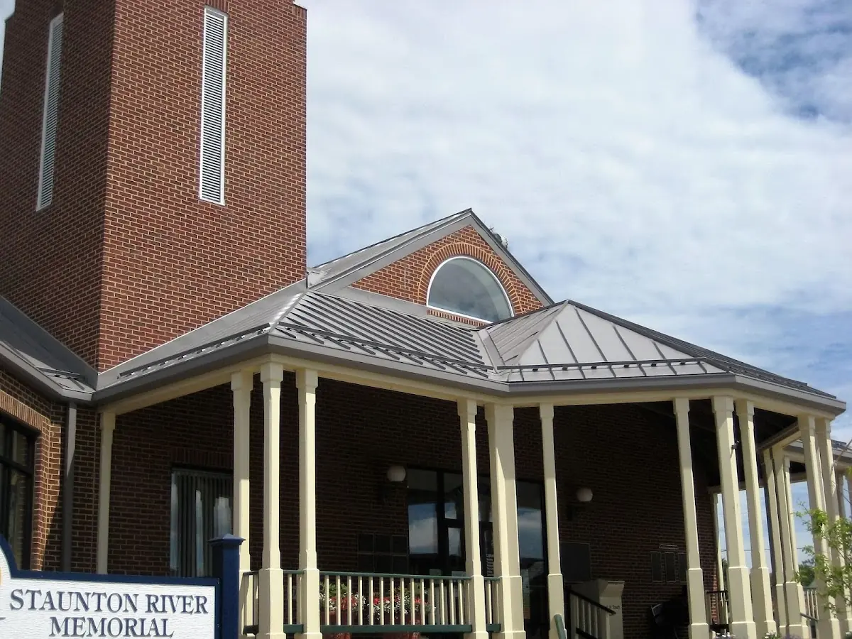 Skilled roofing craftsmen working on a residential roof in Stow